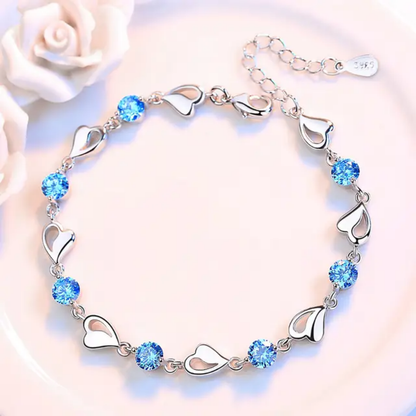 Elegant Silver Heart Charm Bracelet with Sparkling Blue Crystals